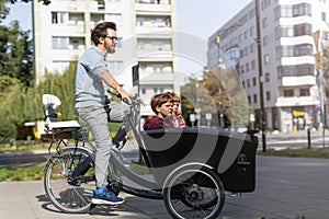 Father and children having a ride with cargo bike