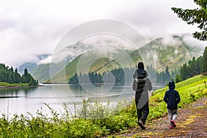 Father with children hiking along beautlful lake with hills cove photo