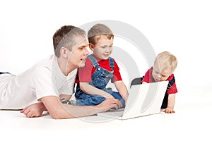 Father and children with laptop