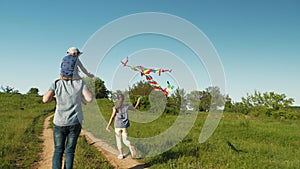 Father with children launching an air kite