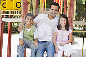 Father with children in playground