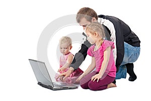 Father with children playing on laptop