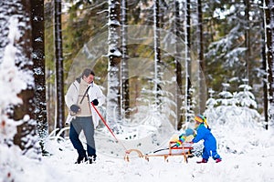 Father and children playing in snow