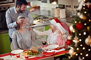 father and children surprises mother with family Christmas dinner.