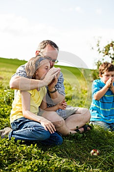 Father and children trying to whistle