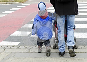 Father with children on zebra crossing