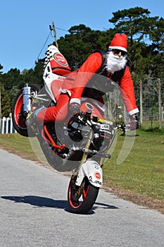 Father Christmas doing front wheel wheelie