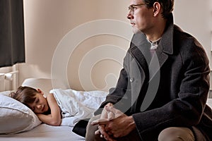 Father come to say goodbye to child boy before leave for work in morning, on bed