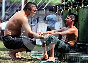 A father comforts his son after he lost his bout at the Kirkpinar Turkish Oil Wrestling Festival at Edirne in Turkey.