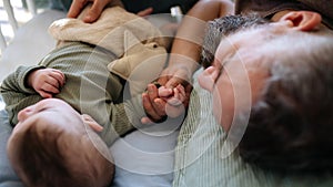 Father cosleeping with baby boy.