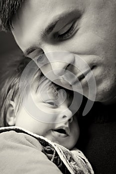 Father cuddling baby son photo