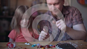 Father and cute child make a model of the solar system in the room.