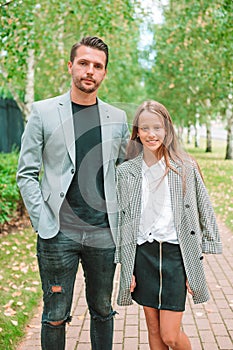 Father and cute daughter outdoor at fall