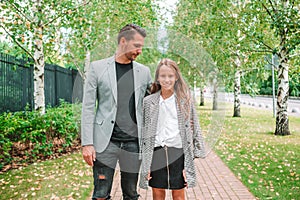 Father and cute daughter outdoor at fall