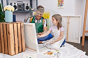 Father and daughter artists smiling confident drawing at art studio