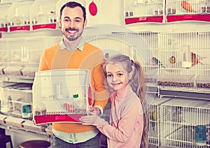 Father and daughter boasting their purchase of canary bird