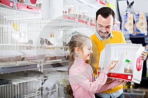 Father and daughter buying canary bird