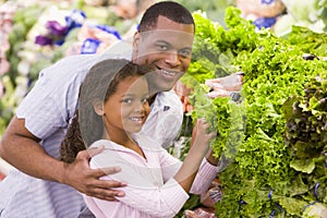 Father and daughter buying fresh produce