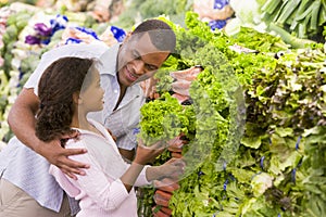 Father and daughter buying fresh produce