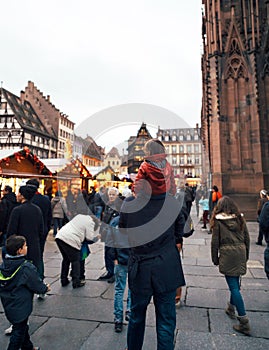 Father and daughter on choulders walking Christmas Market