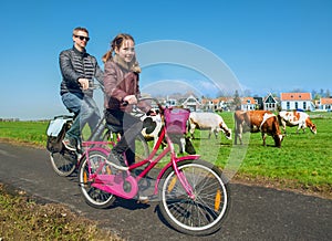 Father and daughter cycling through countryside