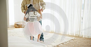 Father and daughter, dancing and love on floor, ballet and support in learning, bonding and care. Family time, play and