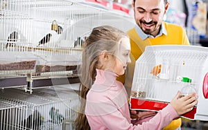 Father and daughter enjoying their purchase of canary bird in pe