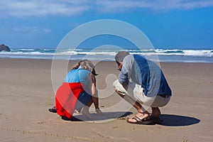 Father Daughter Explore Sandy beach at Low Tide