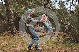 Father and daughter family walking in forest playing together healthy lifestyle summer vacations