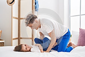 Father and daughter father and daughter doing tickle playing at bedroom