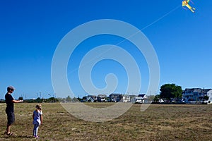 Father and daughter flying kite