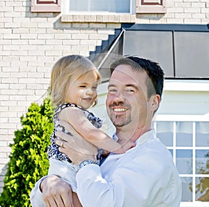 Father and Daughter in Front of House