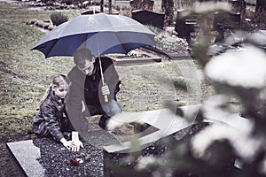 Father and daughter at grave