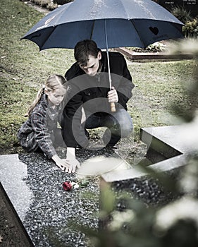 Father and daughter at grave
