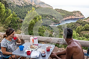 Father and daughter having breakfast in a motor home.