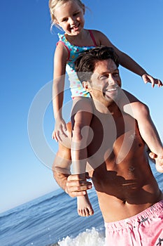 Father And Daughter Having Fun On Beach