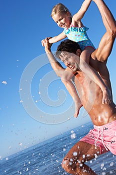 Father And Daughter Having Fun On Beach