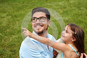 Father And Daughter Having Fun In Park. Family Relaxing Outdoors