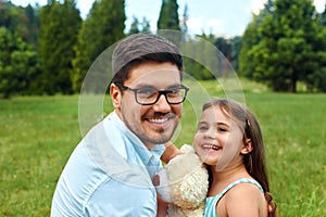 Father And Daughter Having Fun In Park. Family Relaxing Outdoors