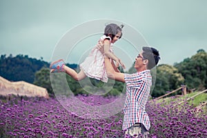 Father and daughter having fun to play together in the garden