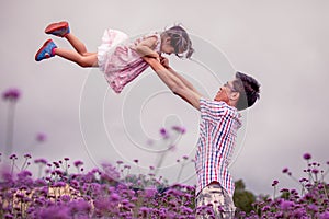 Father and daughter having fun to play together in the garden