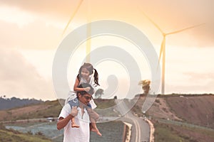 Father and daughter having fun to play in wind turbine