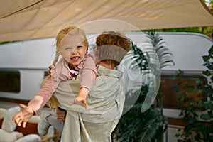 Father and daughter having fun at trailer, campers