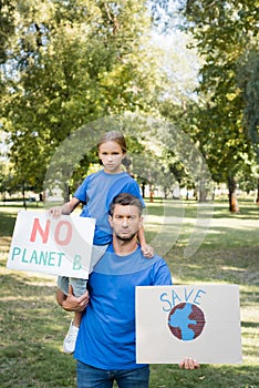 Father and daughter holding placards with