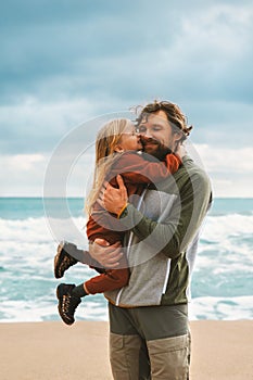 Father and daughter hugging together family lifestyle outdoor child with daddy walking on the beach summer vacations