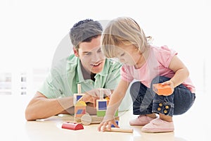 Father and daughter indoors playing