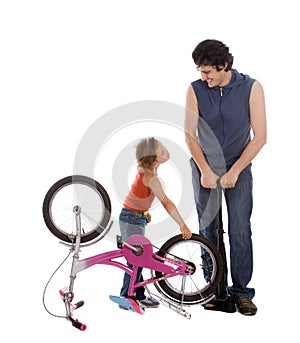 Father and daughter inflate wheel bike photo