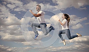 father and daughter jump high. hurry up. happy childhood and fatherhood. concept of friendship