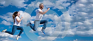 Father and daughter jump on sky, banner with copy space. father and daughter jump high. hurry up. happy childhood and