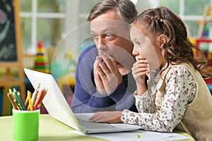 Father and daughter with laptop